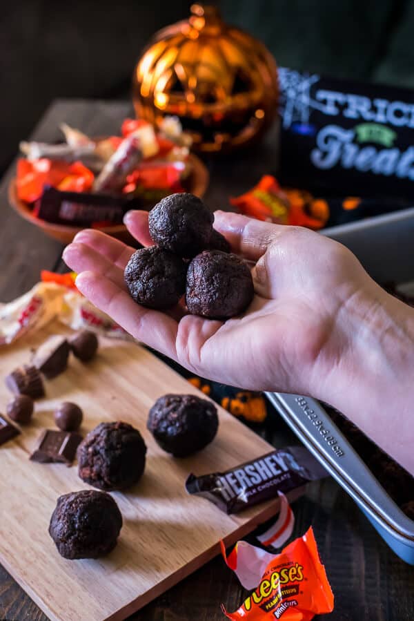 Re-purpose some of that trick-or-treat loot in a batch of these Candy Bar Truffles - chewy, fudgy brownie balls stuffed with your favorite Halloween candy and dipped in chocolate!