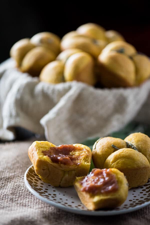 Perfect dinner rolls with a fall twist! These Pumpkin Sage Cloverleaf Rolls are slightly sweet, super fluffy, and smothered in melty sage compound butter.
