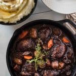 No fear - this classic Coq Au Vin recipe is not nearly as difficult as you might think! Wine-marinated chicken, onions, mushrooms, and carrots are slow simmered in a deliciously rich French red wine sauce, and will be the highlight of your week at the dinner table!