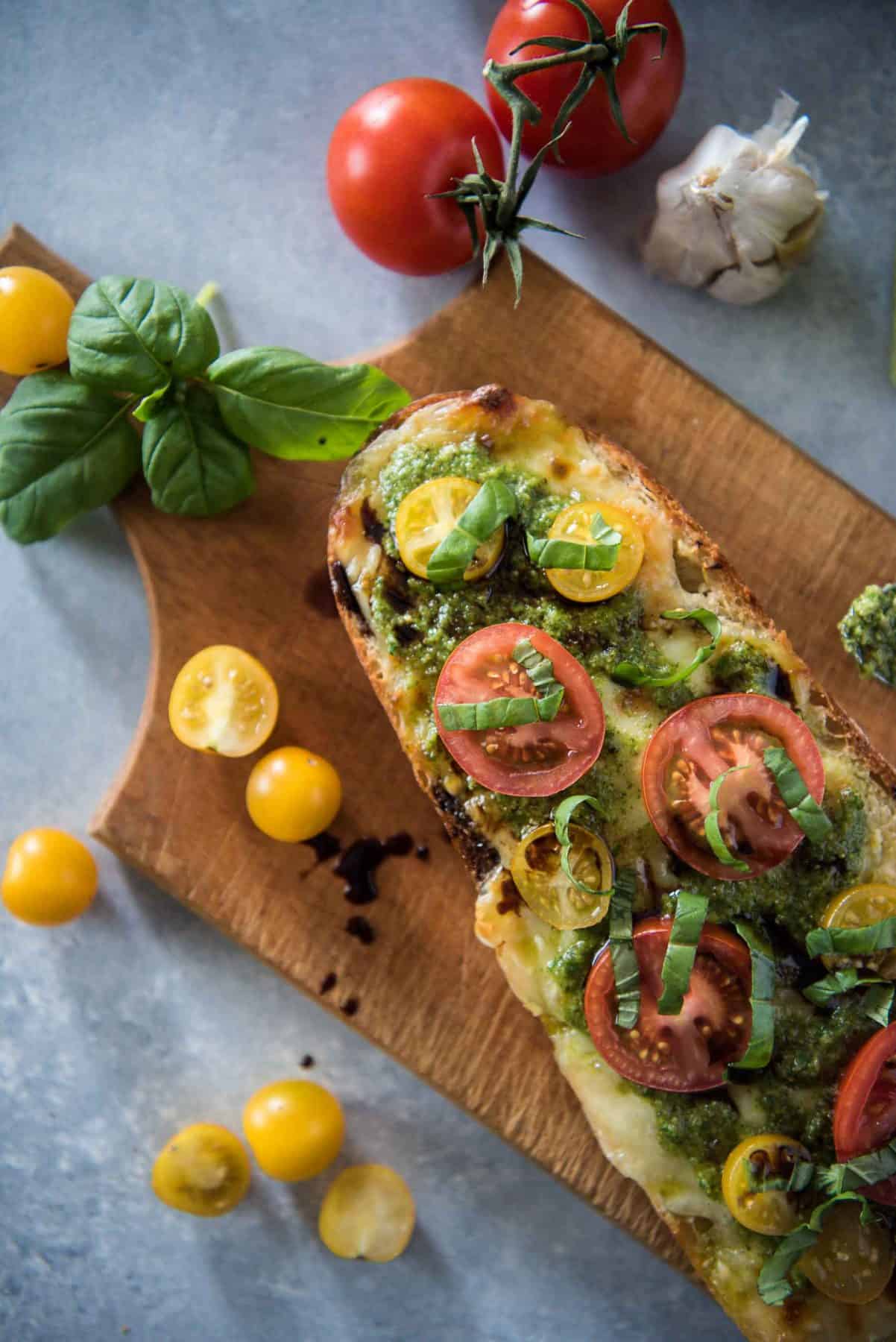 Whether you pair it with your favorite pasta dish or call it dinner by itself, this Caprese Garlic Bread with Arugula Pesto will please the palate of any lover of Italian cuisine!