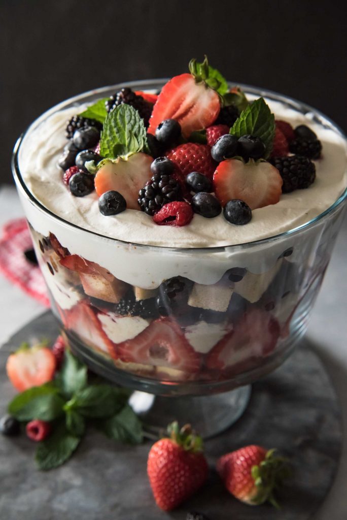 This Chantilly Berry Trifle is a real crowd pleaser! Pound cake, cheesecake filling, whipped cream, and berries marinated in raspberry liqueur make up the layers of this dessert, which is almost too pretty to eat!