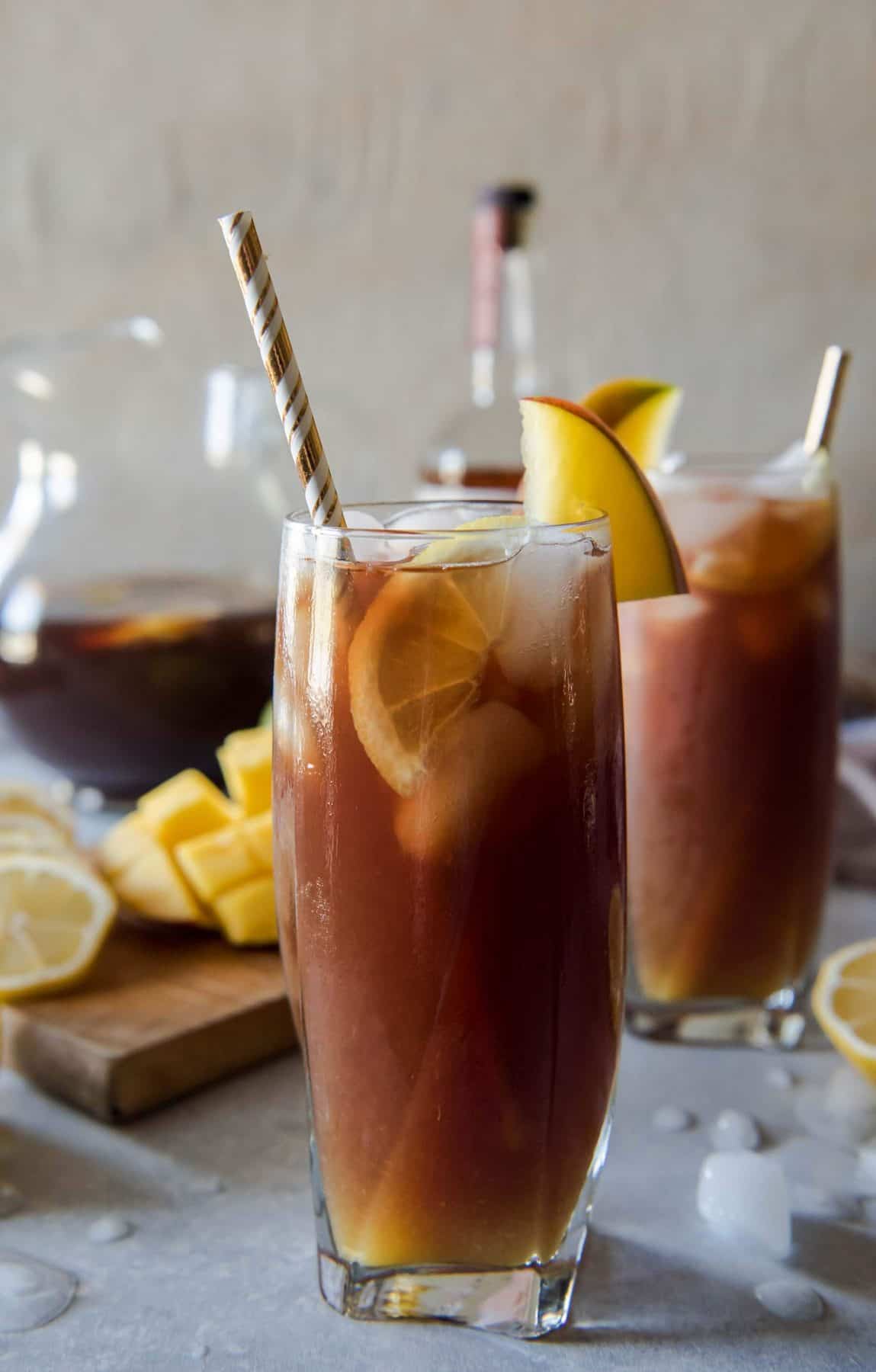 Change up your brunch beverage game with this Southern Spiked Mango Iced Tea! Arnold Palmer-style lemon iced tea combined with homemade mango nectar and a shot of your favorite bourbon is a tasty tropical, Southern way to cool down a balmy morning meal.