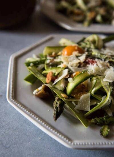 Spring has sprung, and its vegetables are at their peak! This Spring Asparagus Salad is a wonderful way to showcase raw asparagus - thinly sliced and tossed with tomatoes, almonds, Parmesan, mint, and a simple lemon vinaigrette.