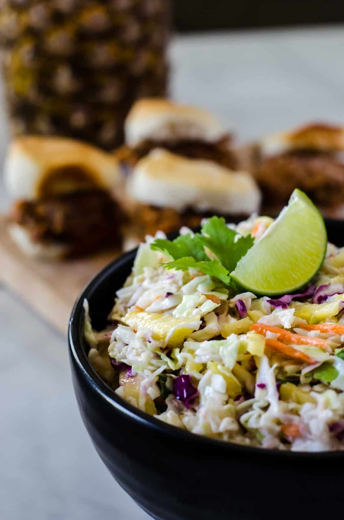 Bring the best dressed slaw to your next BBQ! This fast & easy Fresh Pineapple Coleslaw adds a little tropical flair to the otherwise ordinary side, making it a great topping for everything from sliders to hot dogs!