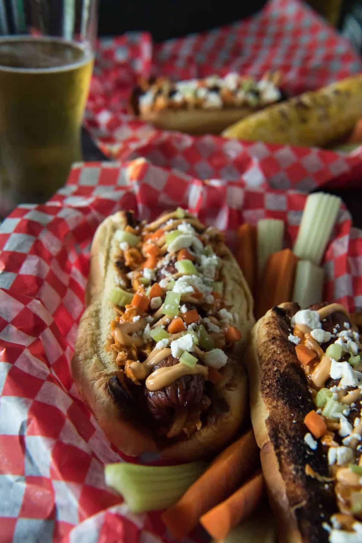 Summer grilling with a kick! Top your Buffalo Hot Dogs with shredded Buffalo chicken, zesty Buffalo mayo, chopped celery & carrots, and blue cheese (or Feta for BCHaters) for a change of pace in your hum-drum dog game!