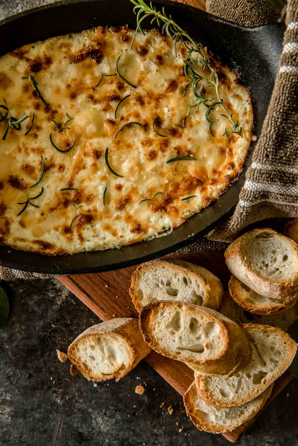 Warm, salty, and extra cheesy, this Baked Ricotta Dip is a delicious appetizer for any occasion. Serve it with slices of your favorite toasted bread and you'll find it hard to stop eating!