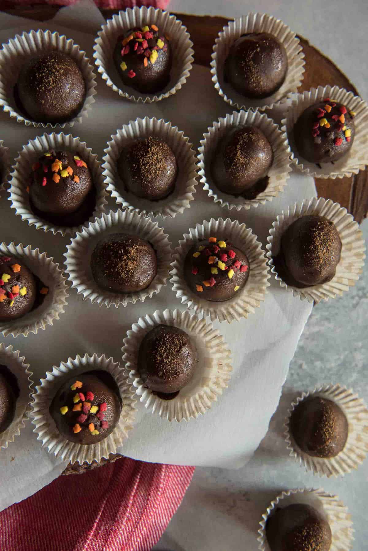 Bite-sized autumn love is found inside these dark chocolate-dipped Pumpkin Cheesecake Truffles, which make perfect party treats! 