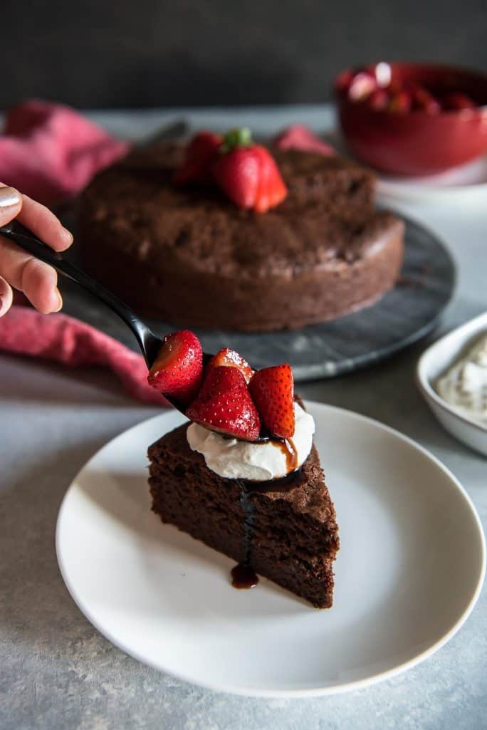 Chocolate Beet Cake with Balsamic Berries and Whipped Mascarpone spooning strawberries