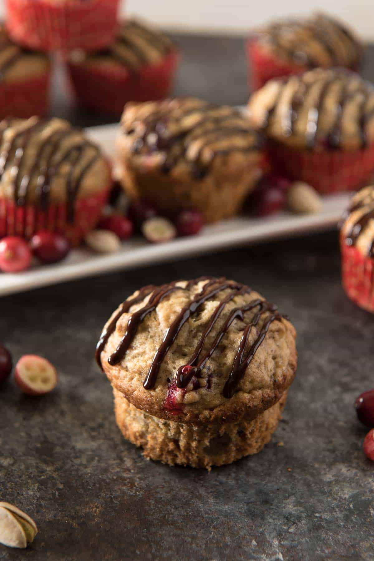 Banana Cranberry Pistachio Muffins with Chocolate Glaze
