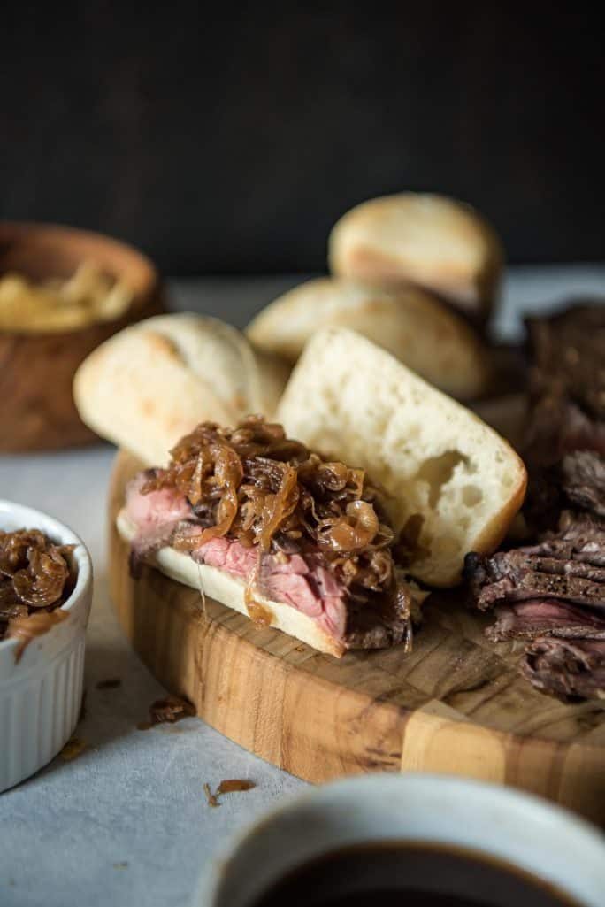 Tender & juicy London broil is the star of these French Dip Sandwiches with Caramelized Onion Au Jus, but slices from leftover holiday roasts would be equally delicious!
