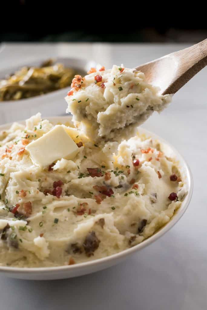 These Homestyle Garlic Herb Mashed Potatoes are a must at every family dinner & holiday celebration! Creamy, buttery, and wonderfully herby, this purely comforting mashed potato recipe is our favorite!