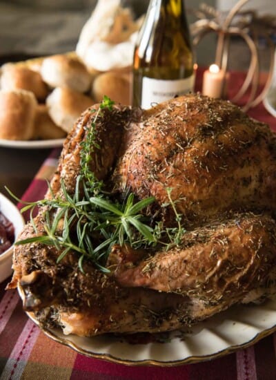 The juiciest holiday bird you'll ever eat! This White Wine and Herb Roasted Turkey is stuffed with fresh root veggies, bathed in white wine, and rubbed with a cocktail of herbs that is guaranteed to delight everyone at the table!