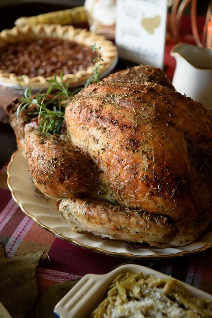The juiciest holiday bird you'll ever eat! This White Wine and Herb Roasted Turkey is stuffed with fresh root veggies, bathed in white wine, and rubbed with a cocktail of herbs that is guaranteed to delight everyone at the table!