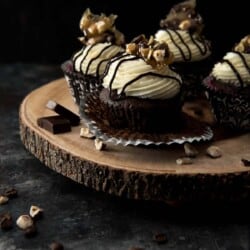 a batch of mocha cupcakes on a wood slice serving plate