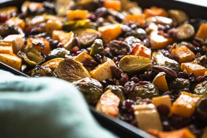 Caramelized veggies, roasted with pecans and tossed with a sweet and tangy glaze - these Roasted Brussels Sprouts & Squash With Cranberry Cider Glaze might be the perfect holiday side dish! 