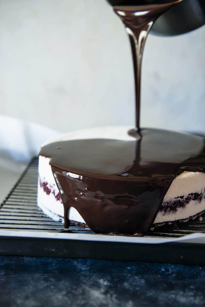 Triple Chocolate Cranberry Mousse Torte being glazed