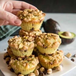 Grabbing Avocado Chocolate Chip Muffins with Pistachio Crumble