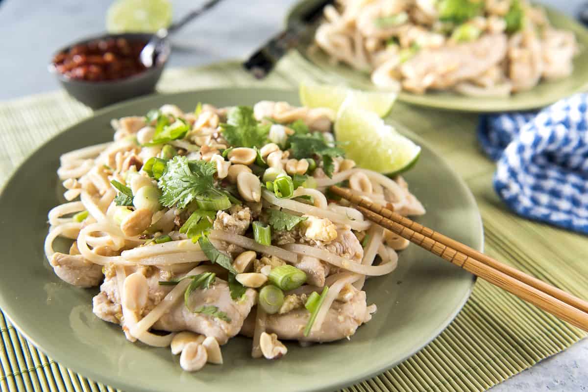 Chicken Pad Thai noodles on a plate with chopsticks.