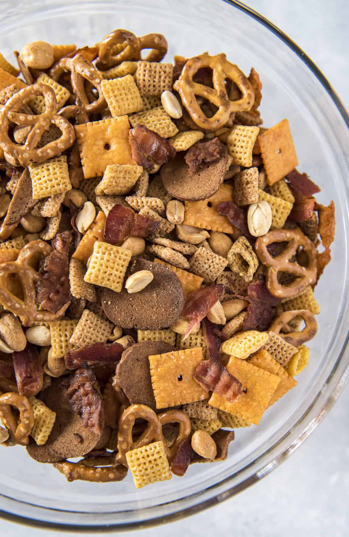 top shot of a large glass bowl filled with bourbon bacon chex mix