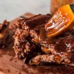 Instant Pot baby back ribs with bourbon barbecue sauce on a cutting board.