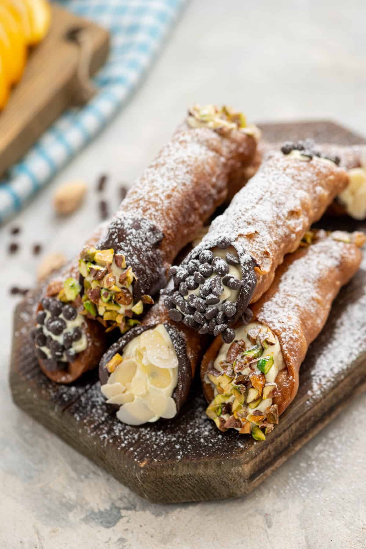 a stack of homemade cannolis with various garnishes