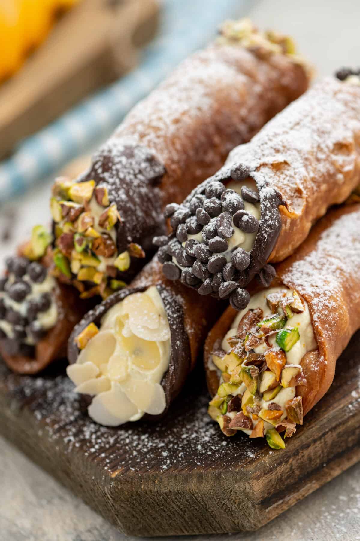 a stack of homemade cannolis with various garnishes