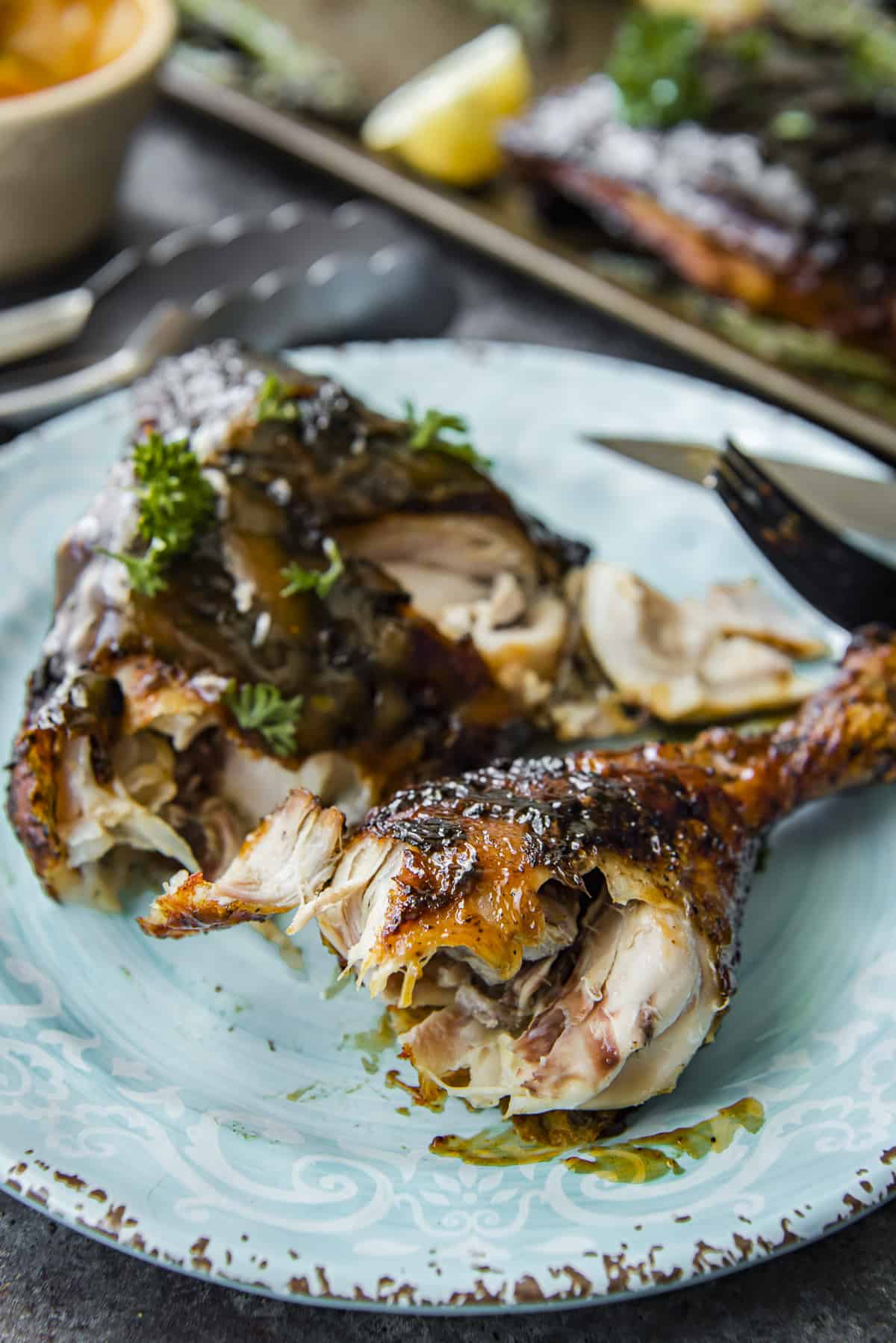 BBQ Grilled Chicken Leg Quarters on a blue plate