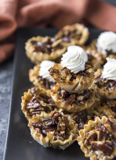 Mini Pecan Pie Tarts stacked on a plate