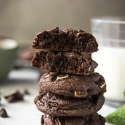 Stack of Mint Chocolate Chip Cake Mix Cookies with a broken cookie on top