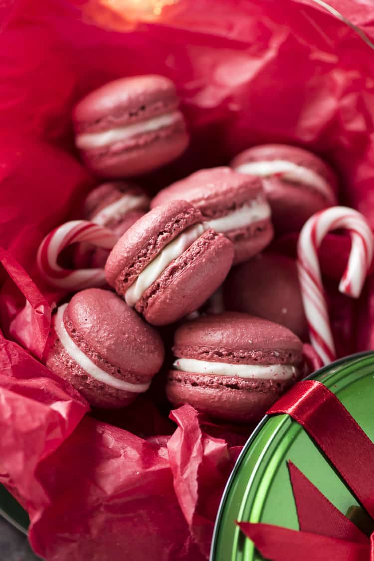Peppermint Red Velvet Macarons in a cookie tin