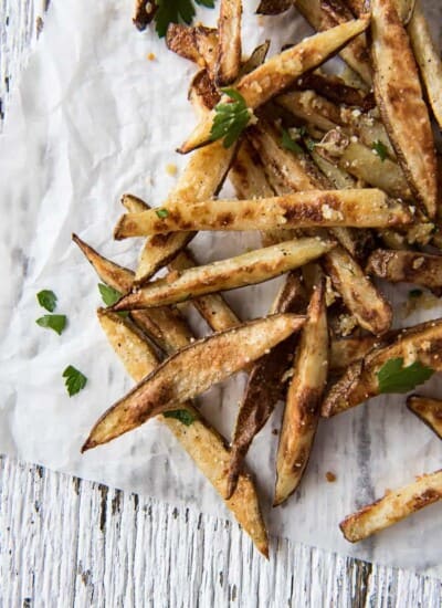 Baked garlic and Parmesan truffle fries on parchment paper