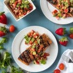 Grilled Salmon on plates with a bowl of Strawberry Salsa