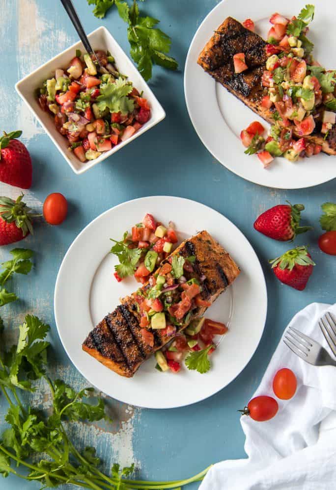 Grilled Salmon on plates with a bowl of Strawberry Salsa