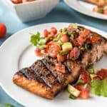 Grilled Salmon on a plate topped with Strawberry Salsa