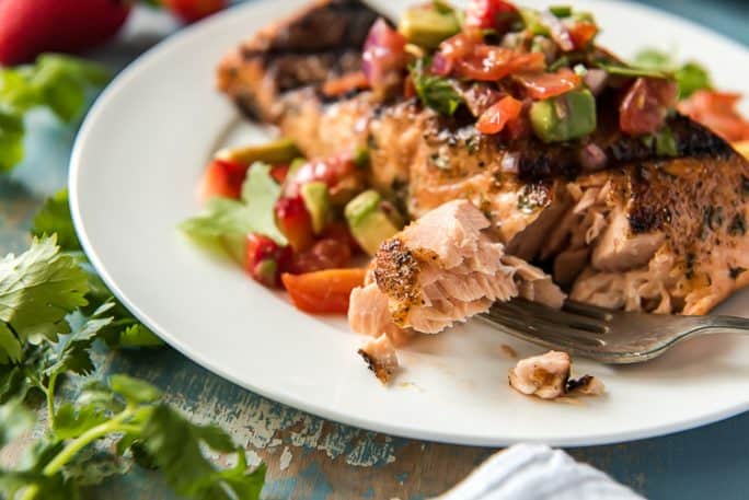 A forkful of Grilled Salmon with Strawberry Salsa