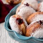 Polish Paczki donuts filled with jam in a blue dish