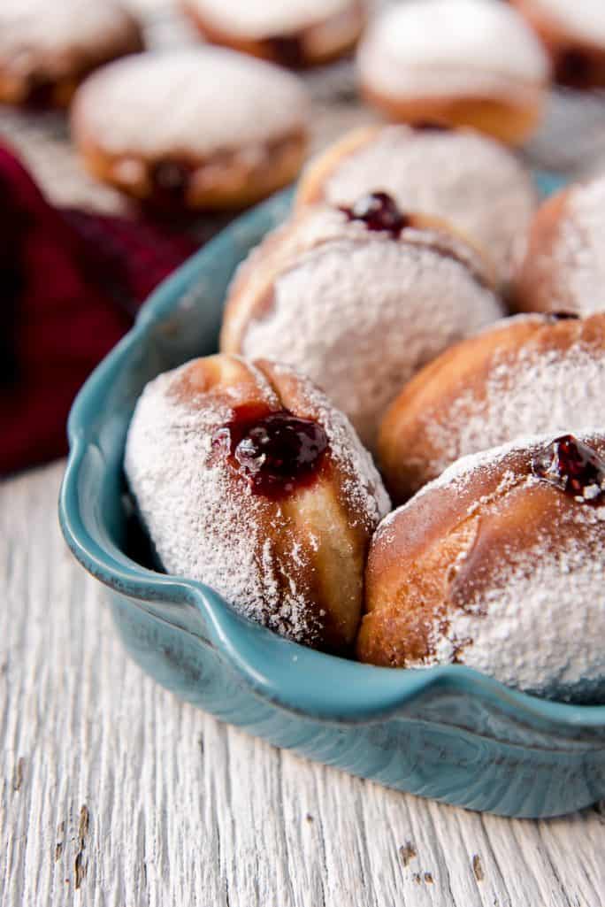 Polish Paczki donuts filled with jam in a blue dish