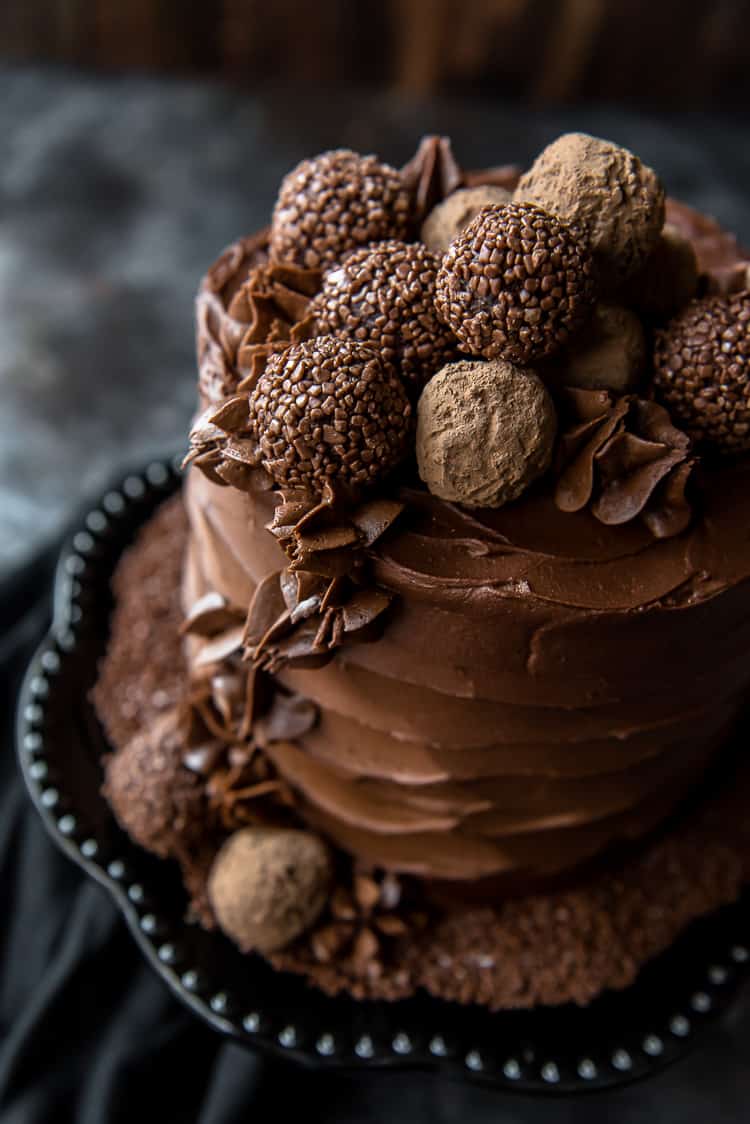 A Chocolate Cake recipe on a black cake stand