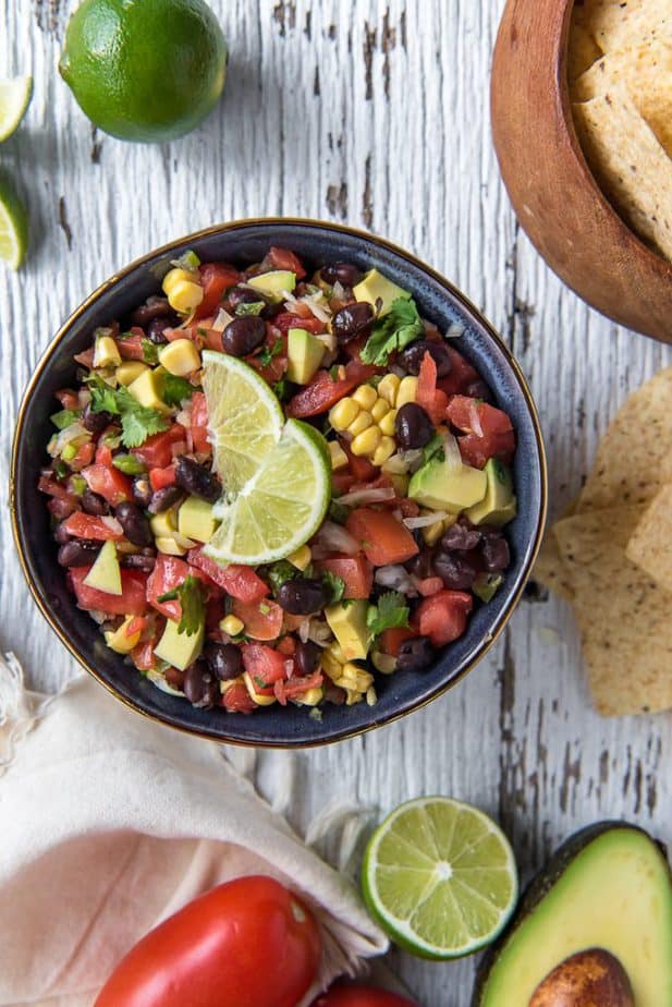 Avocado Black Bean and Corn Salsa in a bowl with tortilla chips