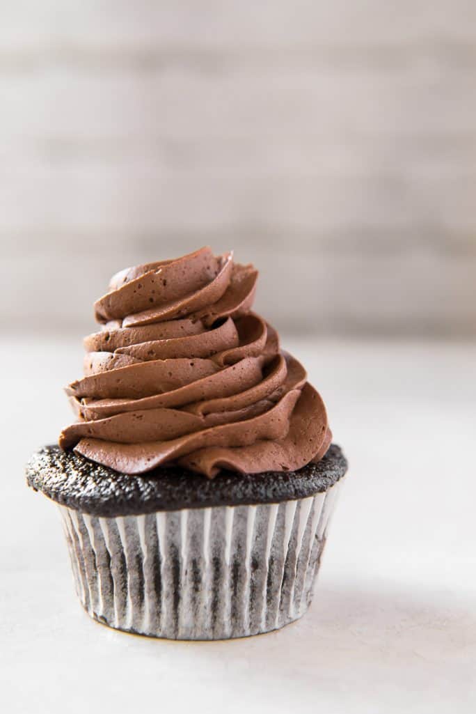 A cupcake topped with Whipped Chocolate Buttercream Frosting