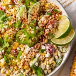 Mexican Street Corn Salad topped with jalapeno and lime in a bowl
