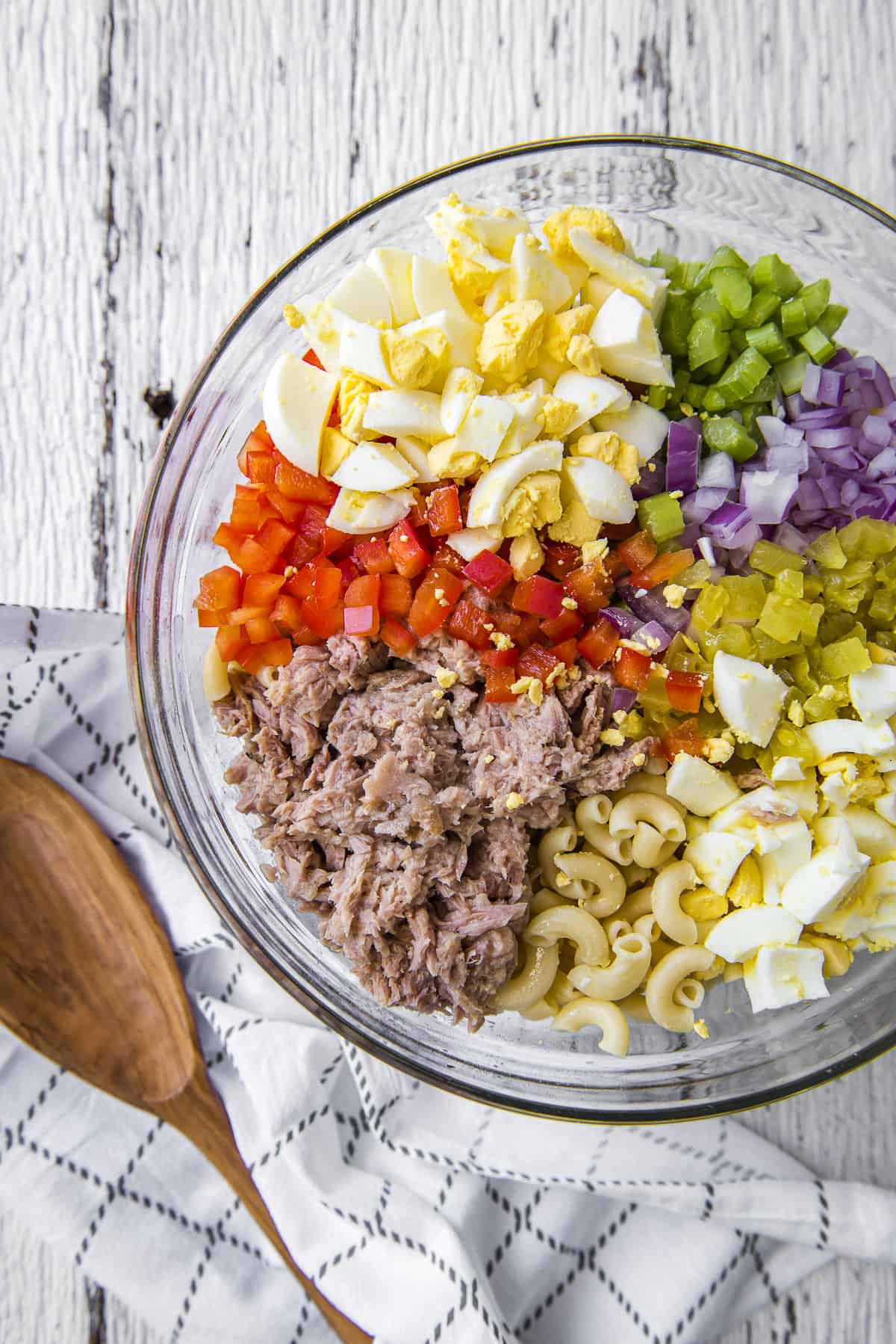 Ingredients for Tuna Macaroni Salad in a glass bowl