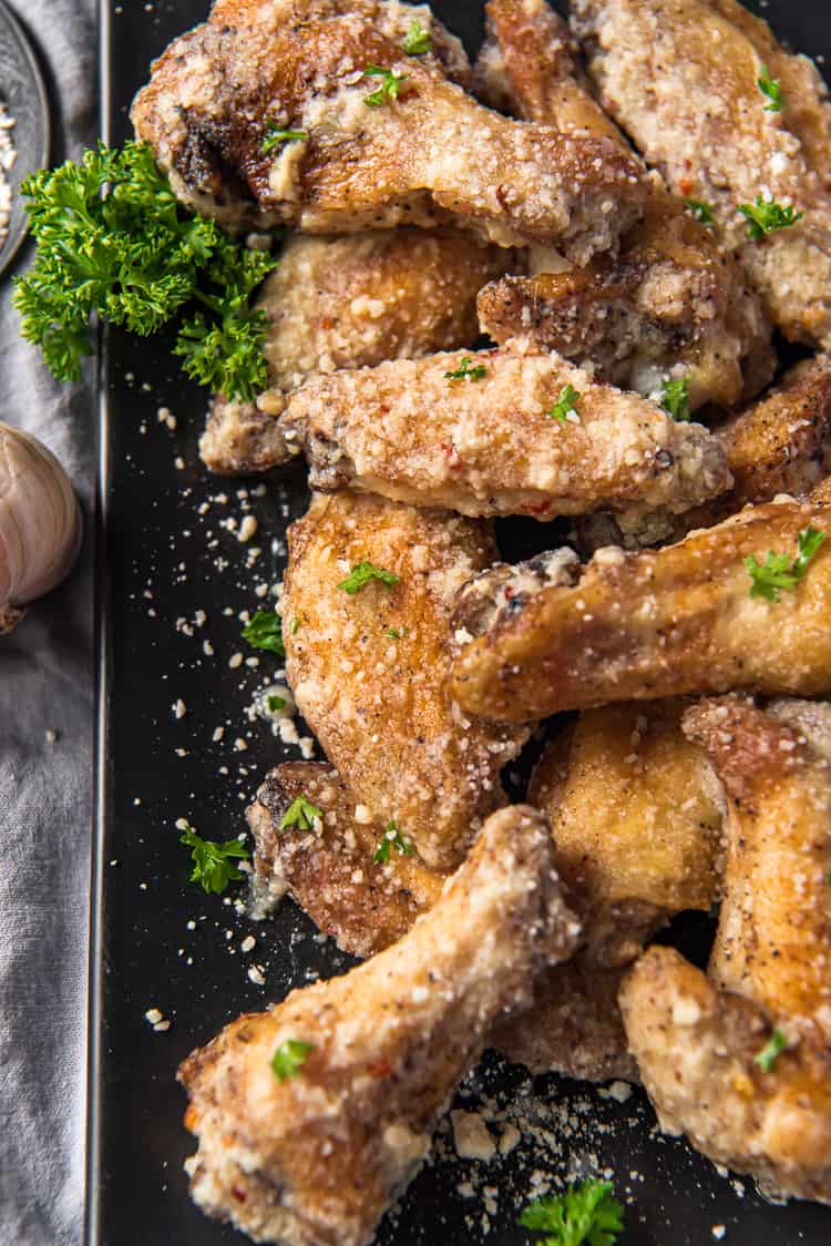 Air Fryer chicken wings tossed in garlic parmesan sauce