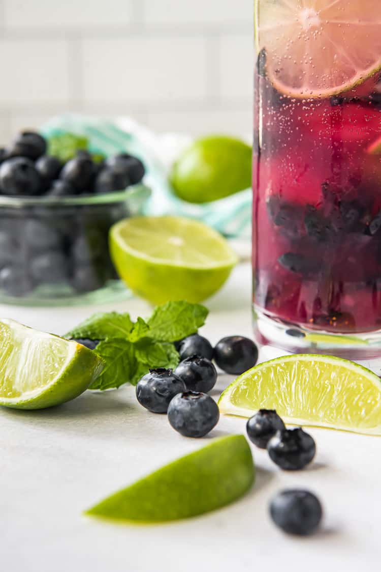 blueberries and limes on a table