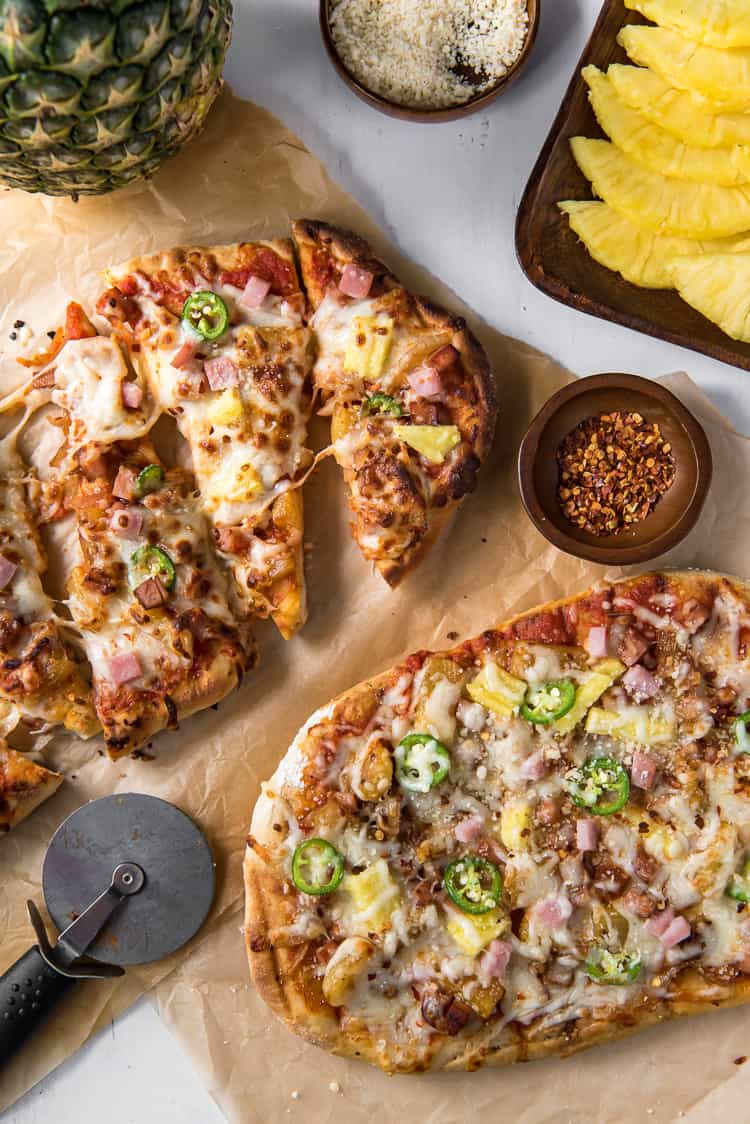 Grilled Hawaiian Pizza with cheese and red pepper flakes