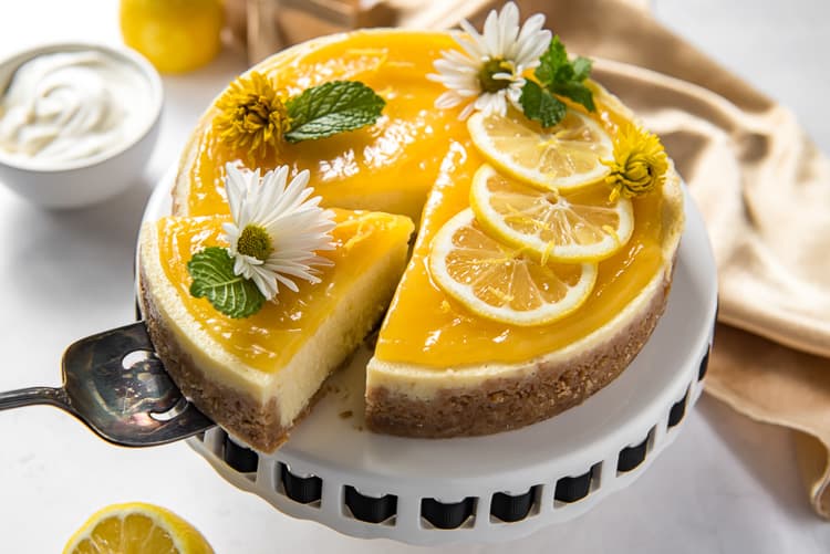 Pulling a slice from an Instant Pot Lemon Ricotta Cheesecake
