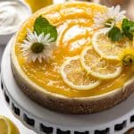 an Instant Pot Lemon Ricotta Cheesecake on a cake stand