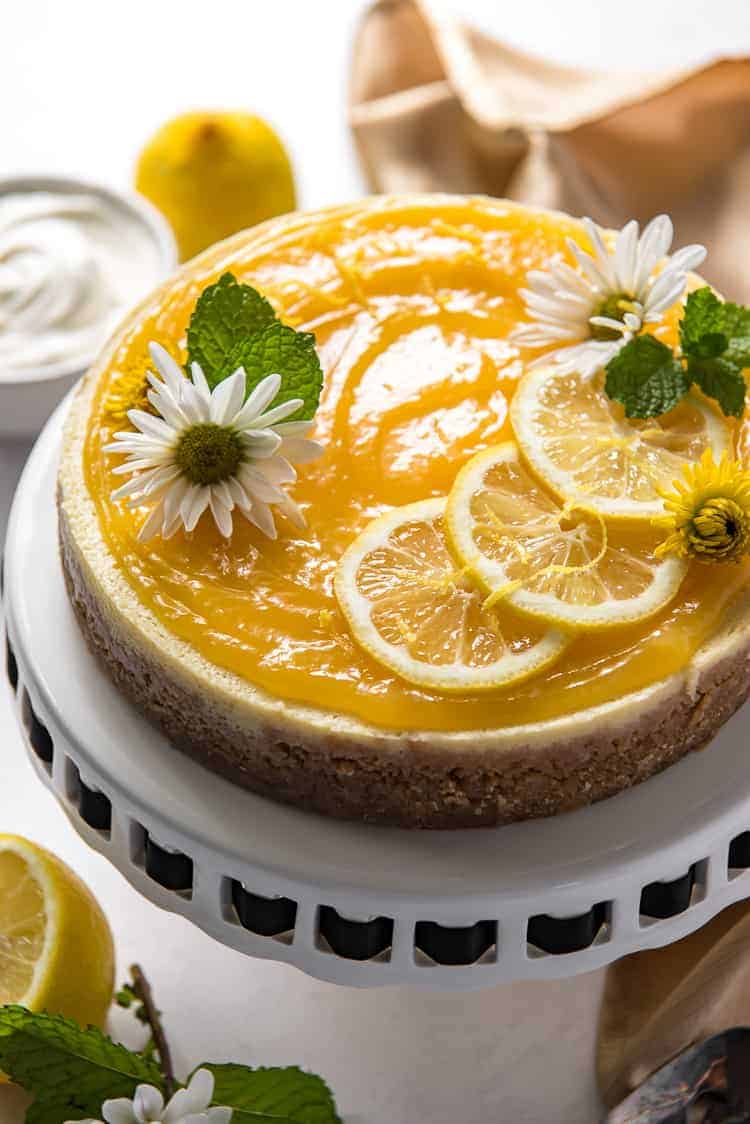 an Instant Pot Lemon Ricotta Cheesecake on a cake stand 