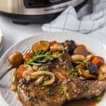 smothered pork chops made in a slow cooker on a plate