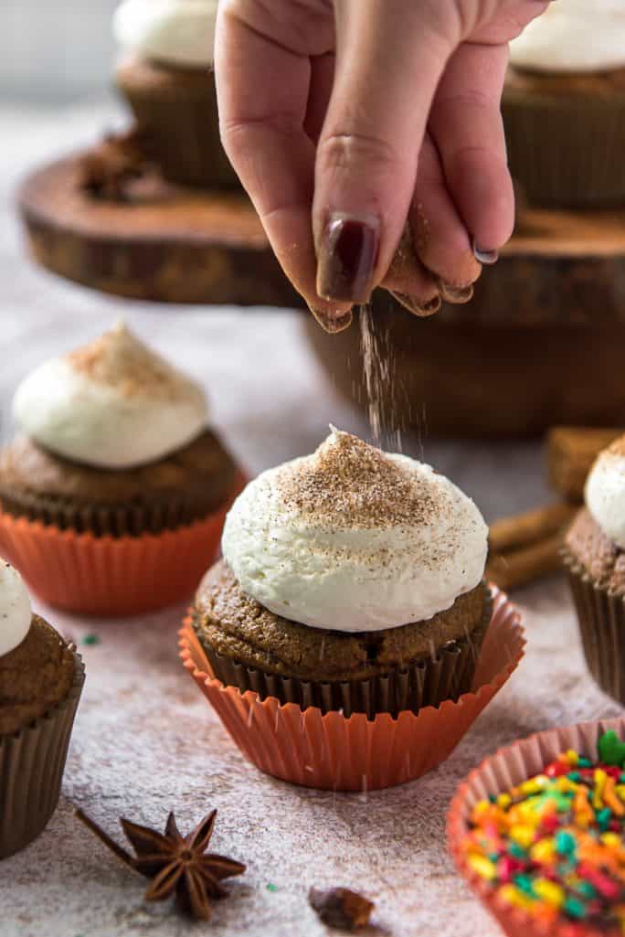 sprinkle cinnamon sugar on a pumpkin cupcake